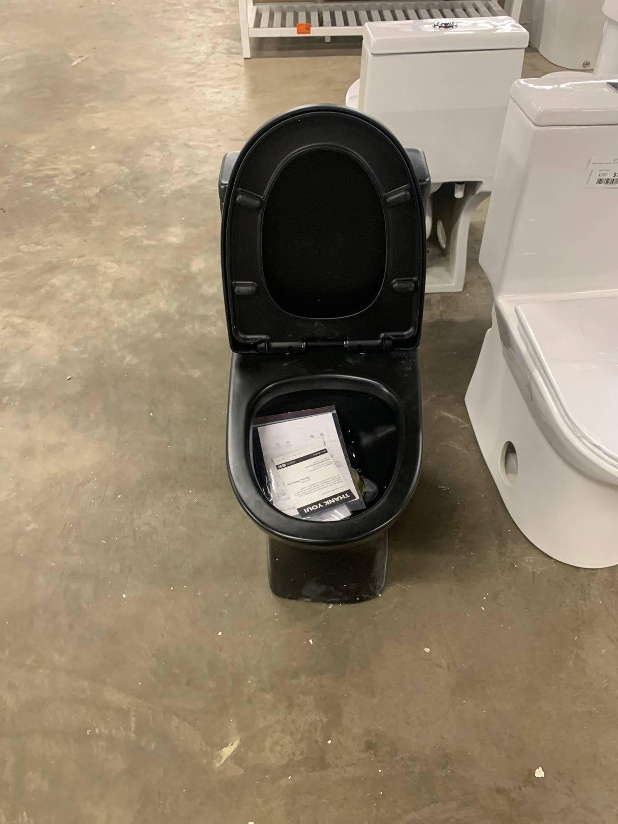 Sublime II 1-Piece 1.1/1.6 GPF Toilet Dual Flush Round Toilet in Matte Black Seat Included