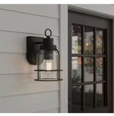 Camberly 12.13 in. Matte Black Motion Sensing Dusk to Dawn Outdoor Hardwired Wall Lantern Sconce with Clear Glass Shade