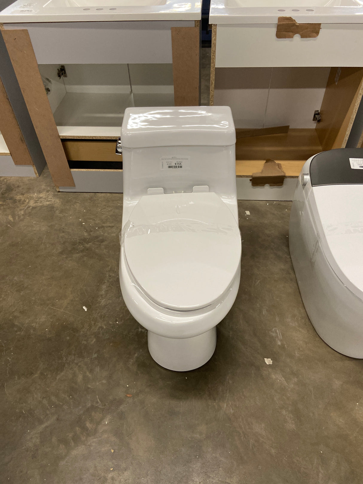 Colony 1-Piece 1.28 GPF Single Flush Elongated Toilet in White Seat Included