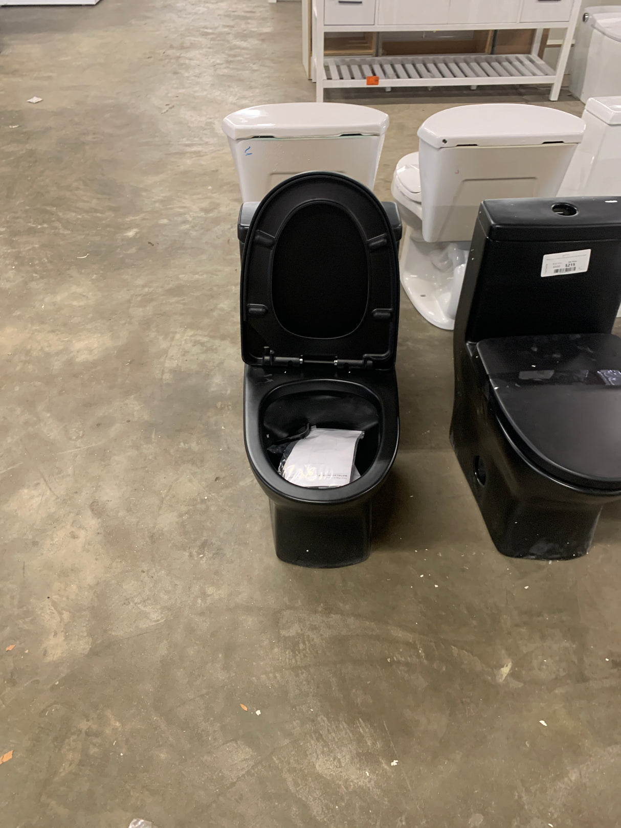 Sublime II 1-Piece 1.1/1.6 GPF Toilet Dual Flush Round Toilet in Matte Black Seat Included