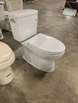 Drake Modern 10 in. Rough In Two-Piece 1.28 GPF Single Flush Elongated Toilet in Cotton White, Seat Included