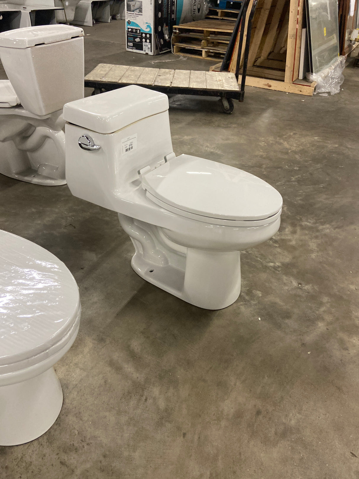 Colony 1-Piece 1.28 GPF Single Flush Elongated Toilet in White Seat Included