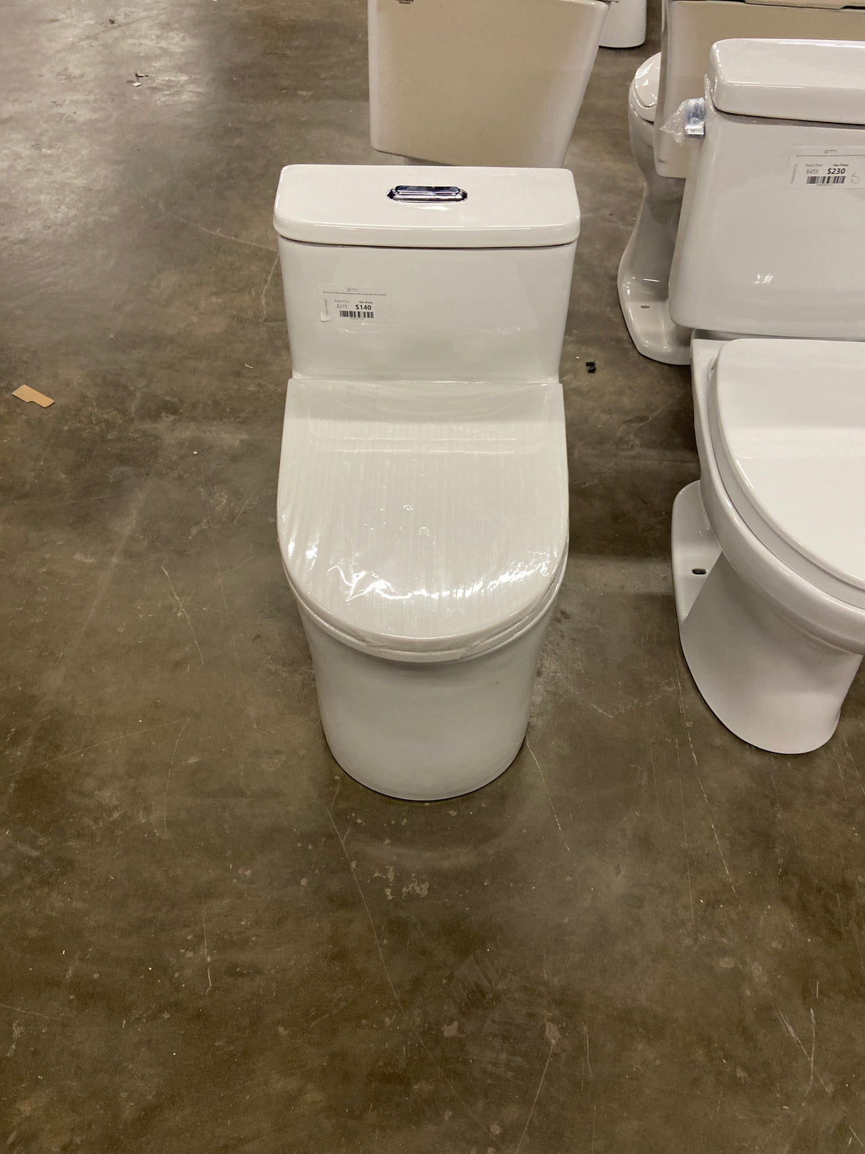 One-Piece 1.28 GPF Dual Flush Elongated Toilet in Glossy White (Seat Included)