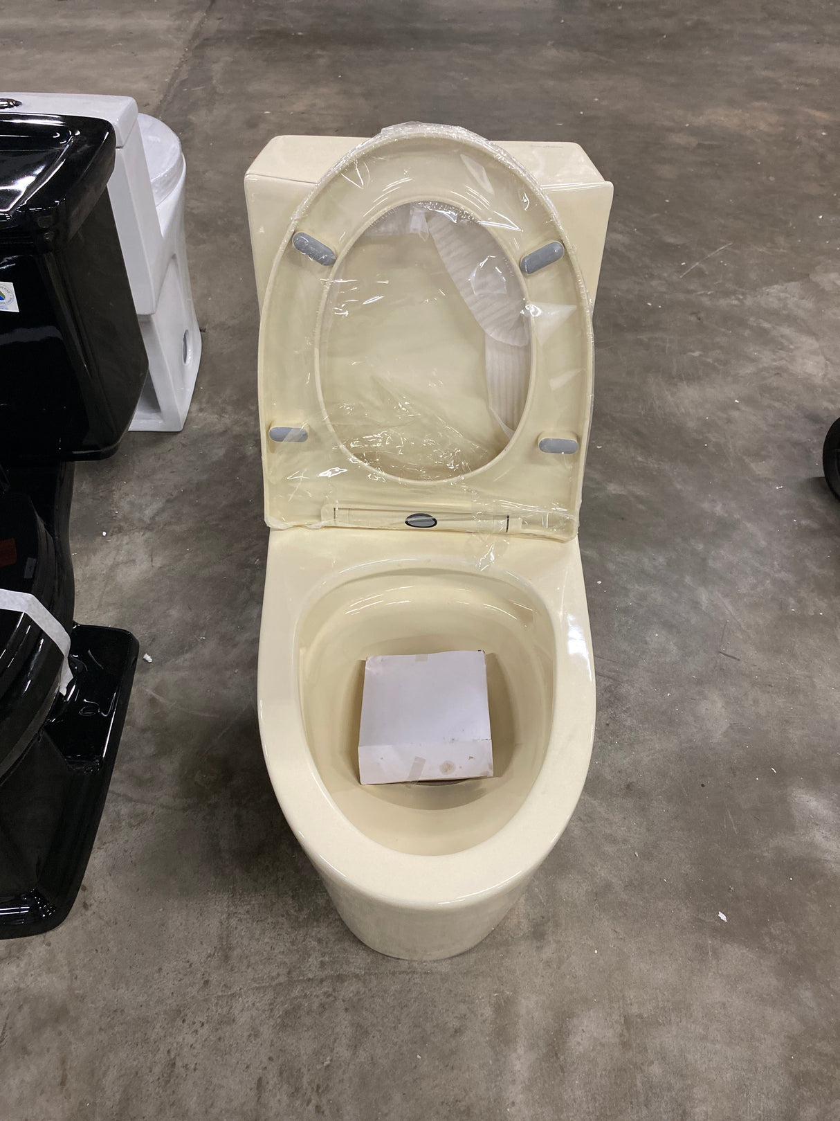 St. Tropez 1-Piece 1.1/1.6 GPF Dual Flush Elongated Toilet in Bisque Seat Included