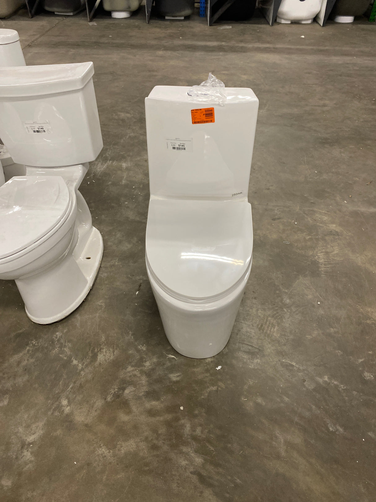 St. Tropez 10 in. 1-piece 1.1/1.6 GPF Dual Flush Elongated Toilet in Glossy White, Seat Included