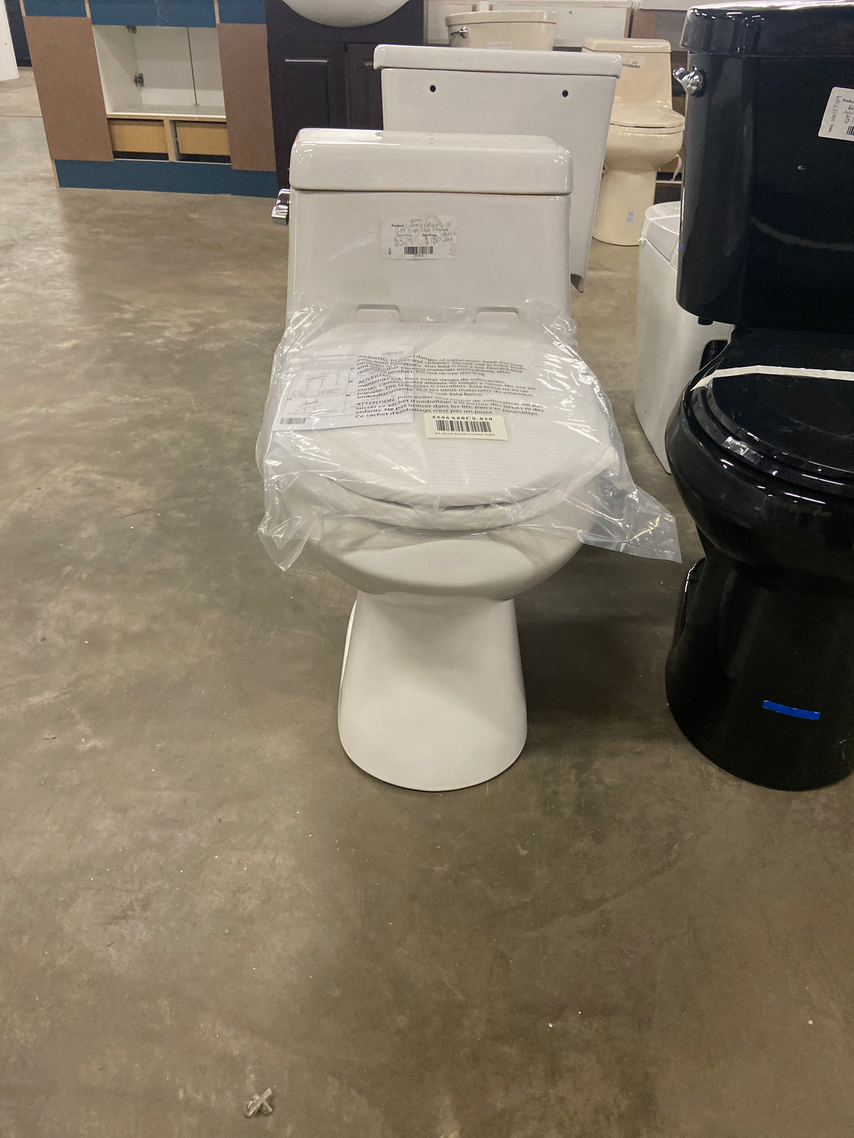 Colony 1-Piece 1.28 GPF Single Flush Elongated Toilet in White Seat Included