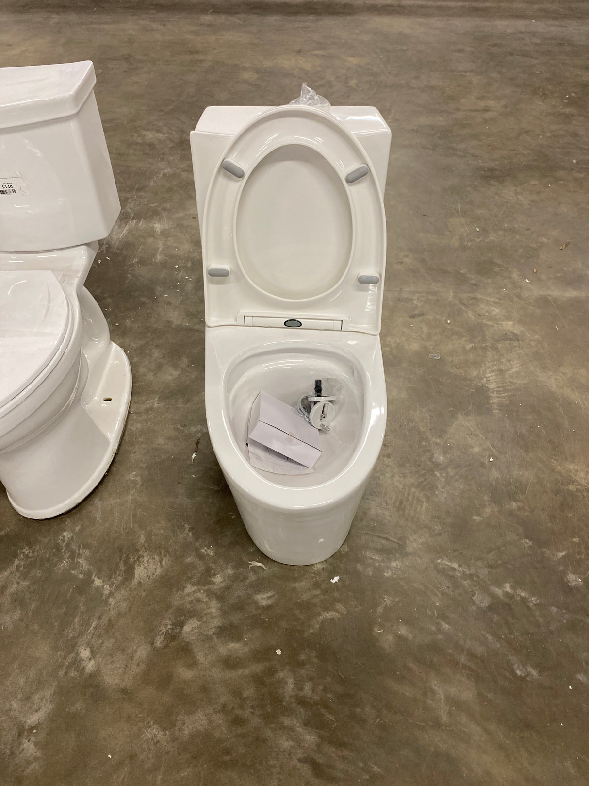 St. Tropez 10 in. 1-piece 1.1/1.6 GPF Dual Flush Elongated Toilet in Glossy White, Seat Included