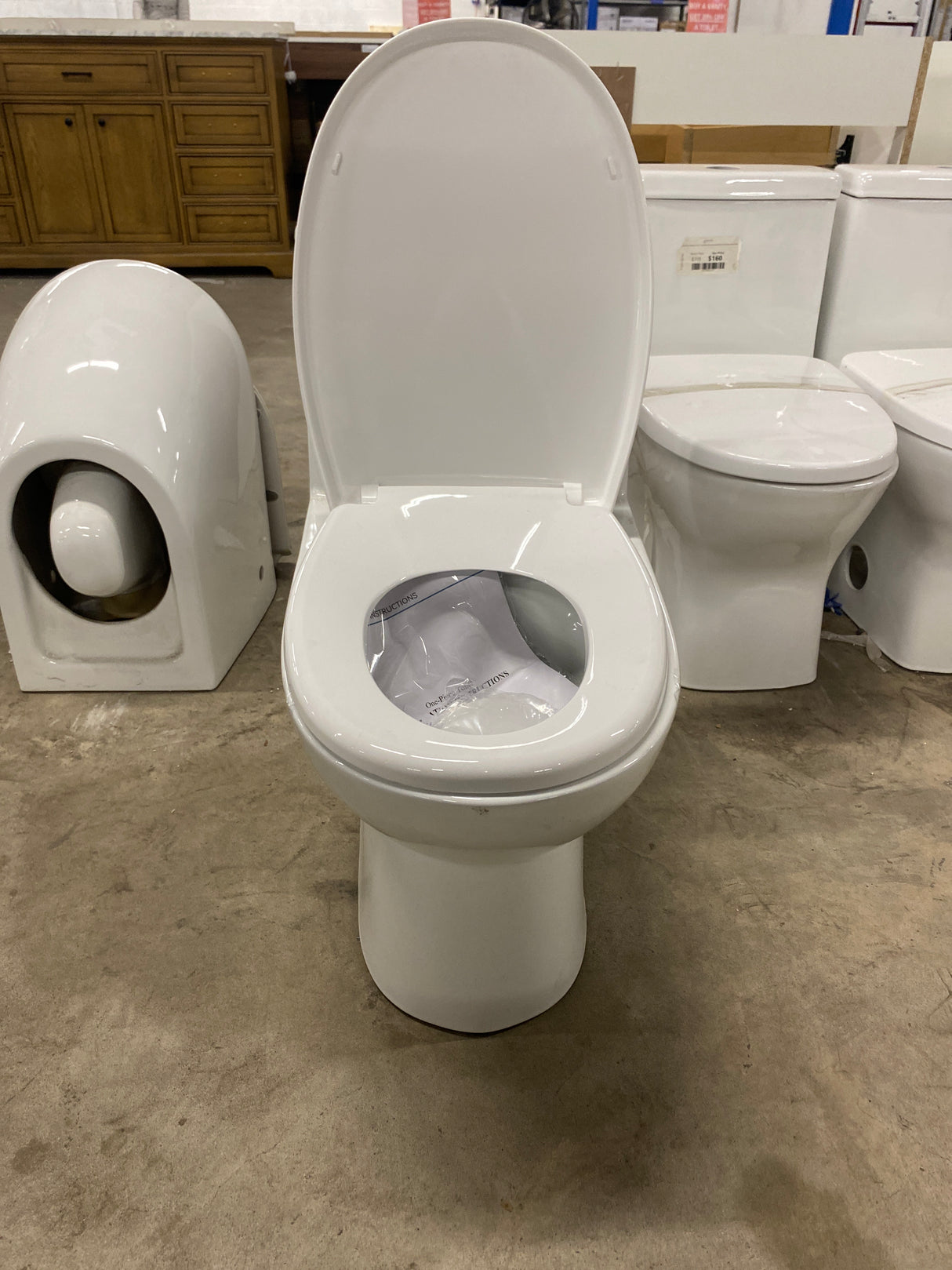 One-Piece 1.1/1.6 GPF Dual Flush Round Toilet in White Soft Close Seat Included