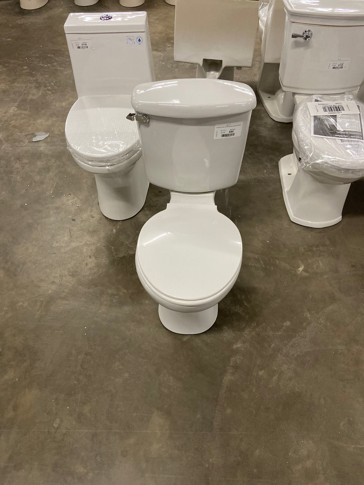 Foundations 2-Piece 1.28 GPF Single Flush Round Toilet in White