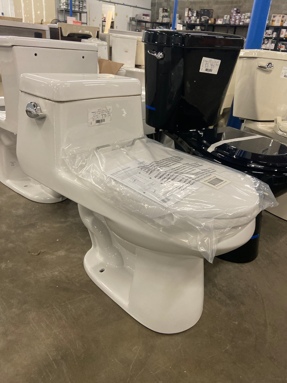 Colony 1-Piece 1.28 GPF Single Flush Elongated Toilet in White Seat Included