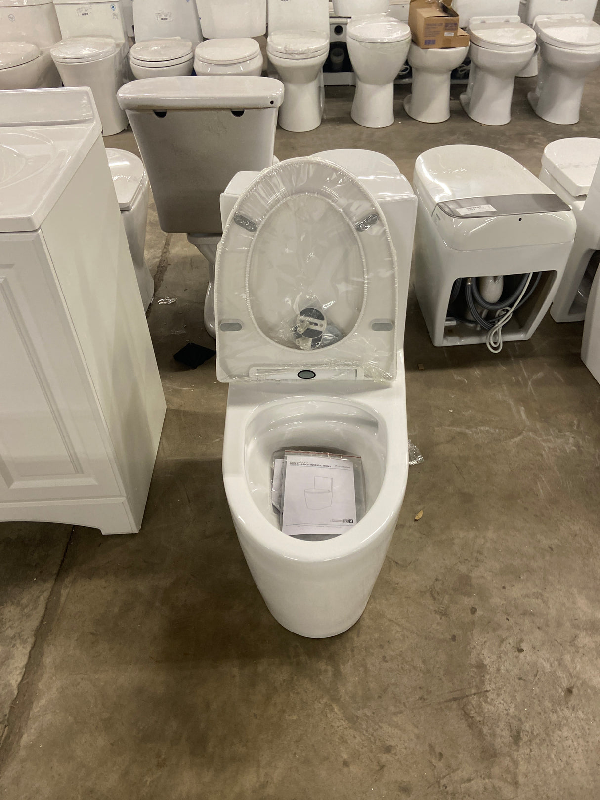 St. Tropez 1-Piece 1.28 GPF Single Flush Elongated Toilet in White Seat Included