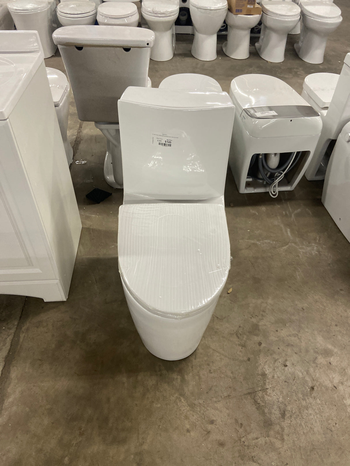 St. Tropez 1-Piece 1.28 GPF Single Flush Elongated Toilet in White Seat Included