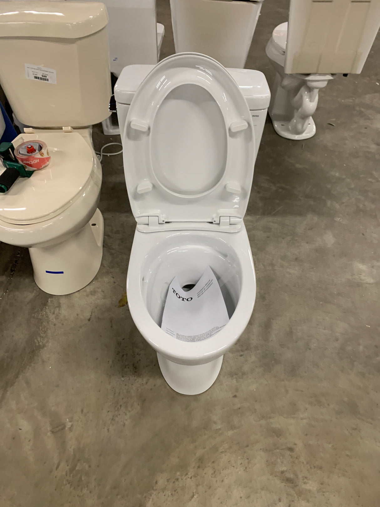 Drake Modern 10 in. Rough In Two-Piece 1.28 GPF Single Flush Elongated Toilet in Cotton White, Seat Included